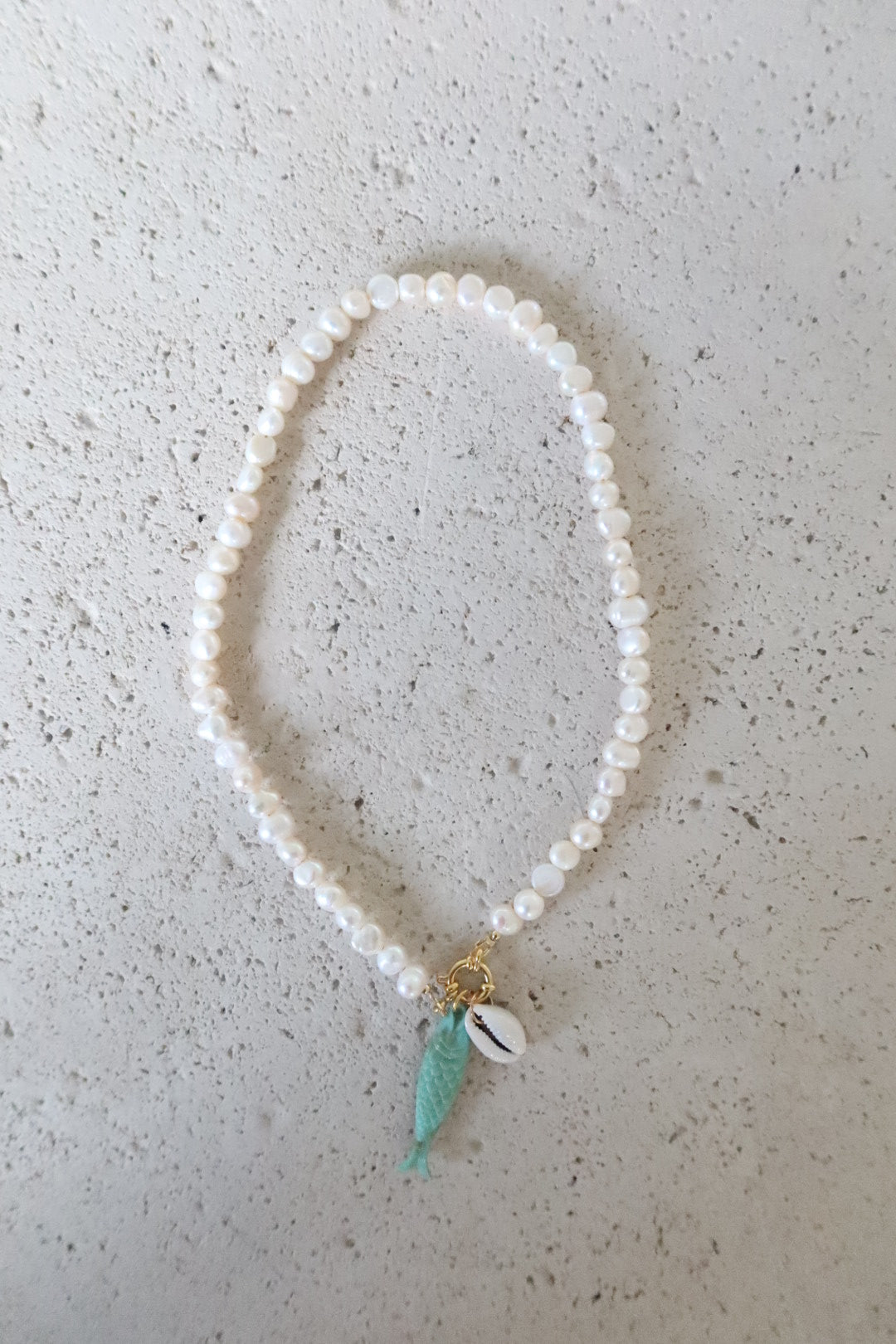 Cowrie Shell and Turquoise Fish on Pearl